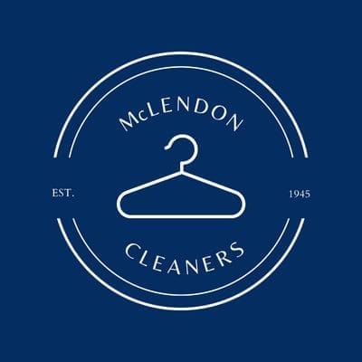 A white hanger icon in a circular logo with the text "McLENDON CLEANERS" and "EST. 1945" on a dark blue background.