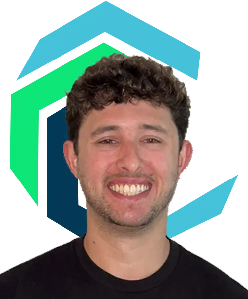 Smiling man with short curly hair wearing a black shirt, in front of a stylized geometric blue and green logo on a white background.