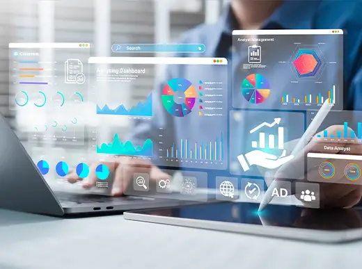 Person using a laptop with digital business analytics dashboards and graphs projected in front, indicating data analysis and technology in a modern office setting.