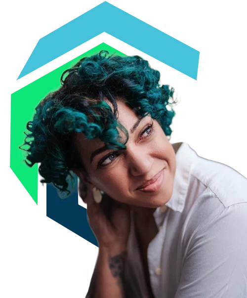 A person with curly teal hair wearing a white shirt looks to the side and smiles, with geometric shapes in blue and green behind them.
