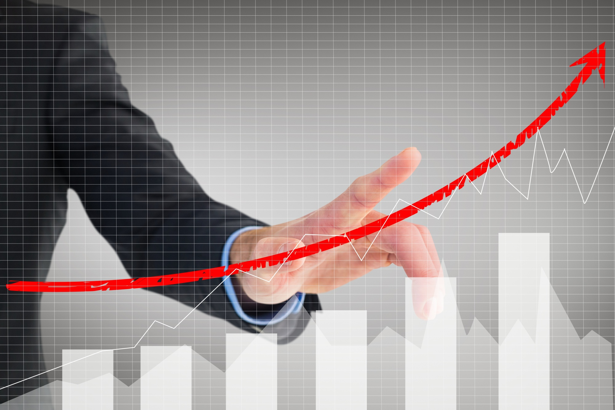 A person in a suit points at a graph with rising bar charts and a red upward trend line, symbolizing growth or success in business or finance.