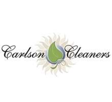 Logo for Carlson Cleaners featuring stylized text with a sunburst and leaf design in the center.