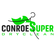 Logo for Conroe Super Dry Clean featuring green and black text, a green hanger, and a stylized green leaf design.