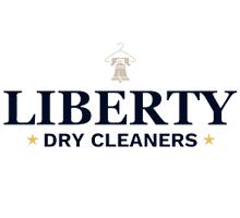 Logo for Liberty Dry Cleaners featuring bold blue text with a small image of the Liberty Bell above and gold stars on either side of "Dry Cleaners" under "Liberty.