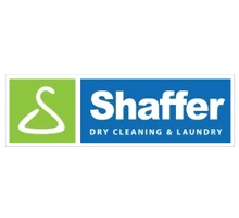 Logo with a green square featuring a white hanger icon next to a blue rectangle with the text "Shaffer Dry Cleaning & Laundry" in white letters.